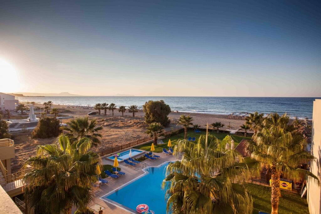 Swimming pool and sandy coast at Ilian Beach Apartments